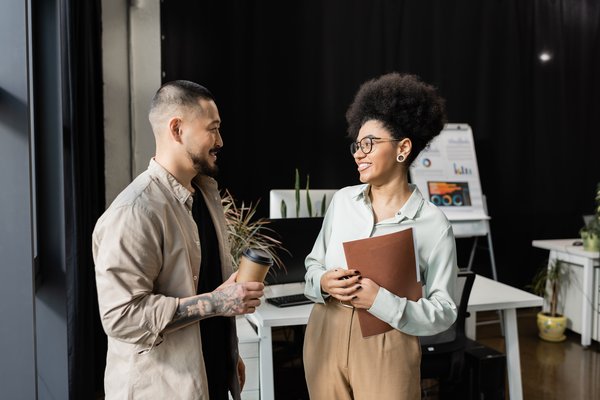 asian-businessman-with-coffee-chatting-with-africa-2023-11-27-05-20-53-utc