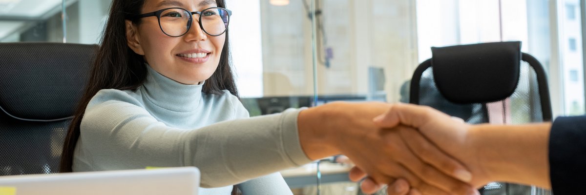 handshake-of-young-happy-asian-businesswoman-in-ey-2023-11-27-04-58-21-utc