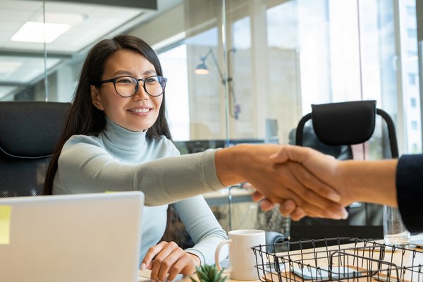 handshake-of-young-happy-asian-businesswoman-in-ey-2023-11-27-04-58-21-utc