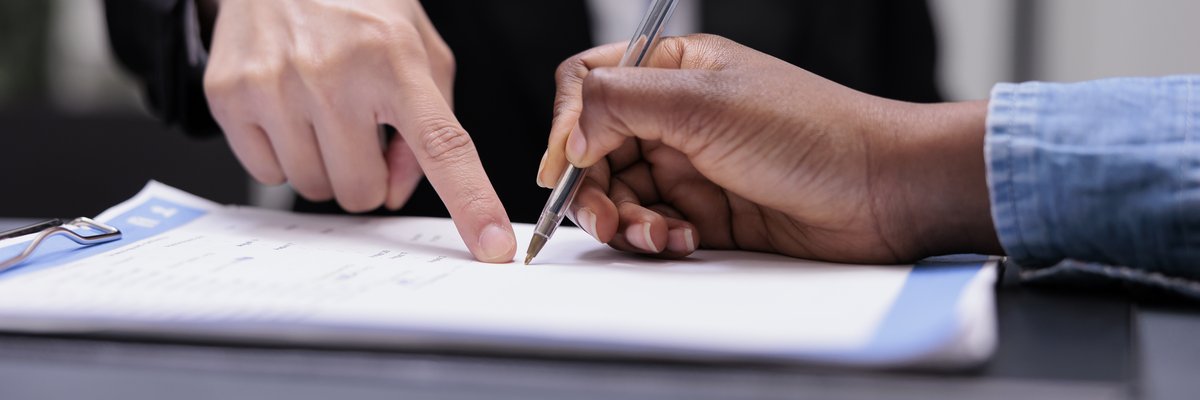 patient-filling-in-report-papers-at-reception-2023-11-27-05-34-21-utc